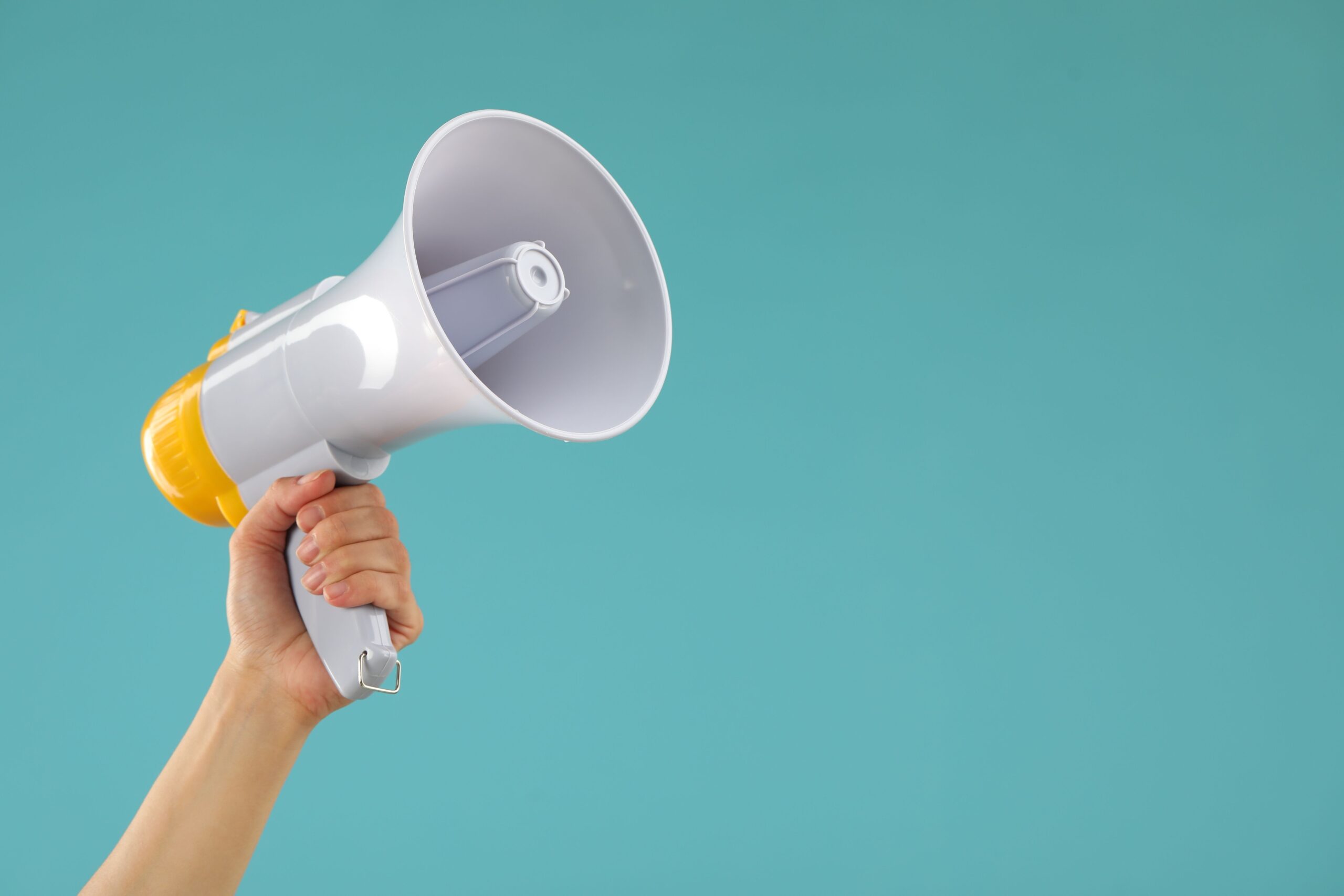 Woman,Holding,Megaphone,Speaker,On,Blue,Background,,Closeup.,Space,For